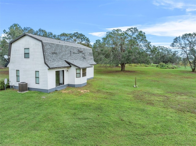 965 Keen Rd, Frostproof, FL 33843 - view of side of home with a gambrel roof, central AC, roof with shingles, and a lawn