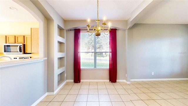 unfurnished dining area featuring light tile patterned floors, built in features, and a chandelier