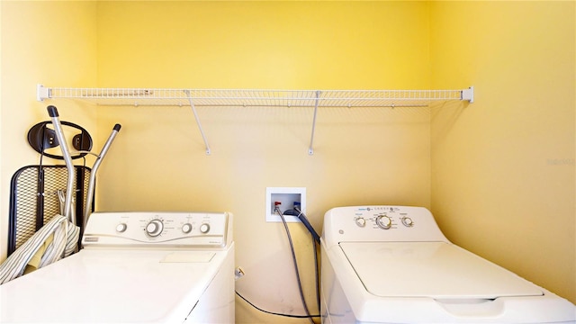 clothes washing area with separate washer and dryer