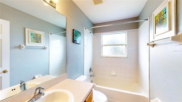 full bathroom featuring vanity, toilet, and tiled shower / bath