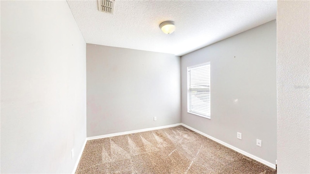 unfurnished room featuring a textured ceiling and carpet floors