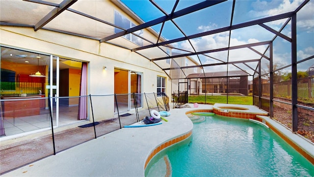 view of pool featuring a patio area, glass enclosure, and an in ground hot tub