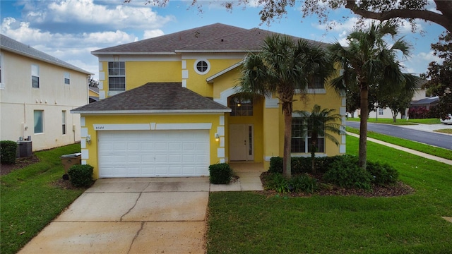 view of front of house featuring a garage and a front lawn