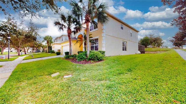 view of property exterior featuring a yard and a garage