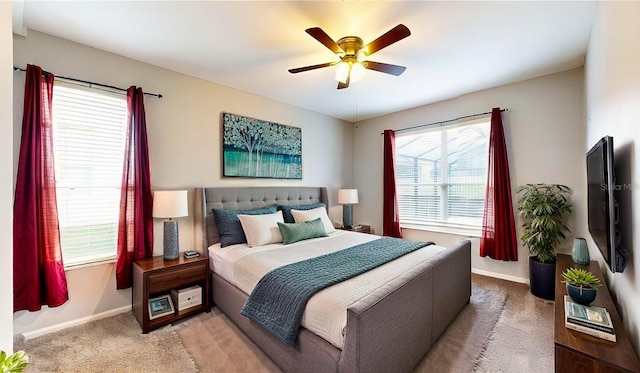 bedroom featuring light colored carpet and ceiling fan