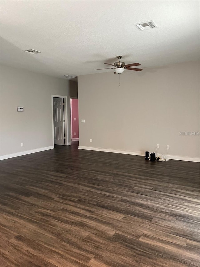 empty room with ceiling fan, a textured ceiling, and dark hardwood / wood-style flooring