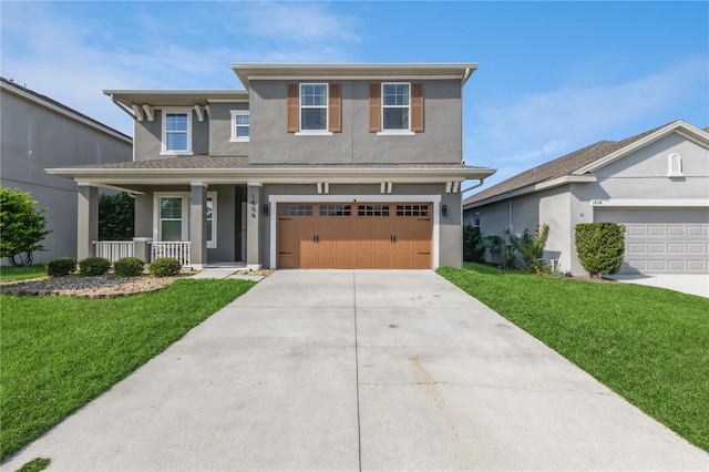 view of front of house featuring a porch, a front lawn, and a garage