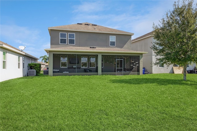 back of house with cooling unit, a lawn, and a sunroom