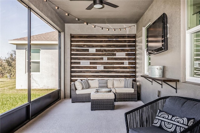 sunroom featuring ceiling fan and a wealth of natural light