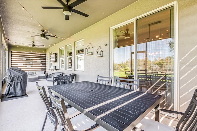 view of patio / terrace with ceiling fan and an outdoor living space