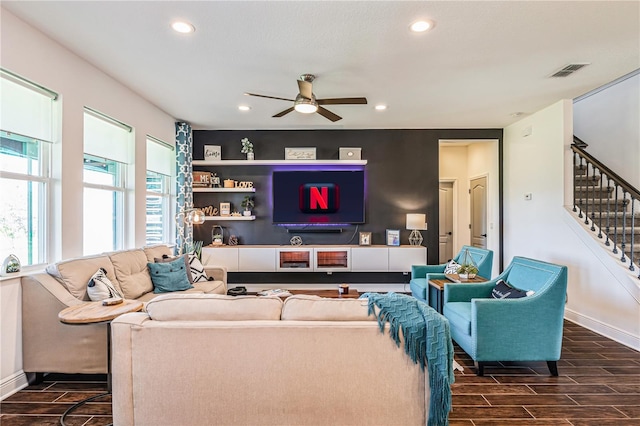 living room with dark wood-type flooring and ceiling fan