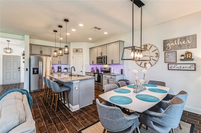 dining area featuring sink and dark hardwood / wood-style flooring