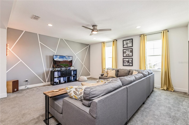 carpeted living room with ceiling fan and a textured ceiling