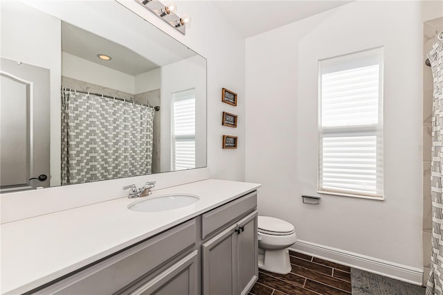 bathroom with vanity, toilet, hardwood / wood-style flooring, and a shower with curtain