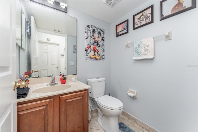 bathroom with vanity, toilet, and tile patterned floors