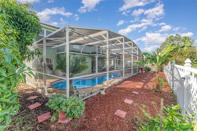 view of swimming pool featuring a lanai