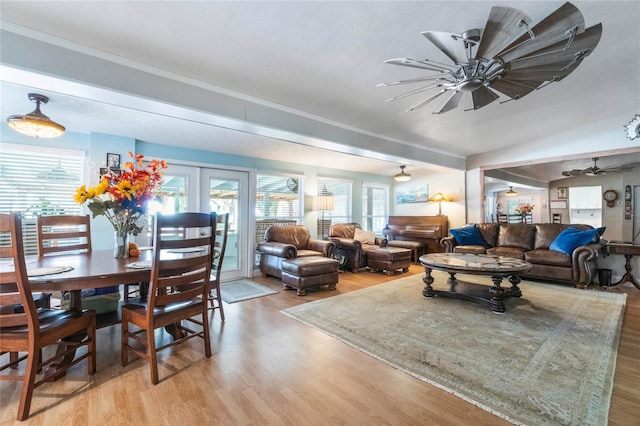 living room with french doors, plenty of natural light, ceiling fan, and light hardwood / wood-style flooring