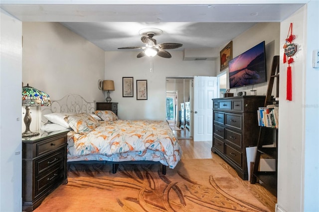 bedroom with light hardwood / wood-style floors and ceiling fan