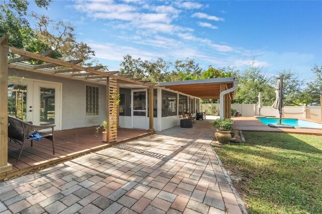 4321 Rummell Rd, Saint Cloud, FL 34769 - fenced backyard with a pergola, a deck, french doors, a sunroom, and a patio area