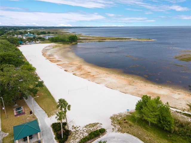 bird's eye view featuring a water view and a beach view