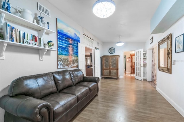 living room with hardwood / wood-style floors and french doors