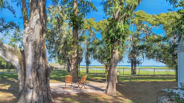 view of yard featuring a water view and a patio area