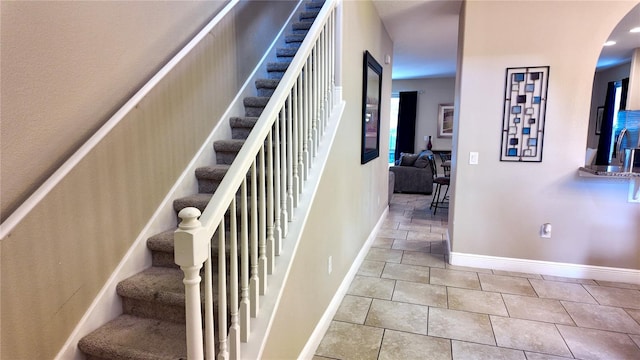 stairway featuring tile patterned floors