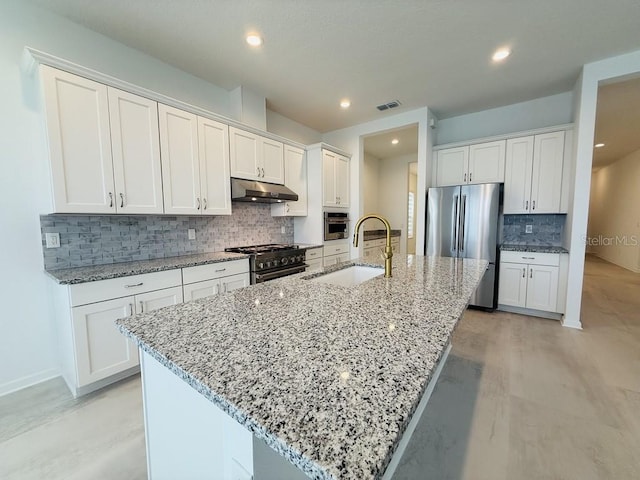 kitchen with an island with sink, white cabinetry, and stainless steel appliances