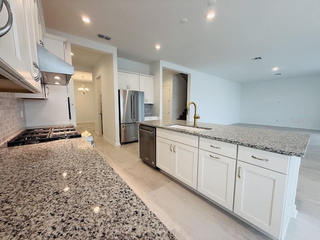 kitchen featuring white cabinets, a sink, and high end refrigerator