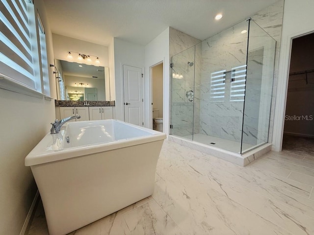 bathroom featuring toilet, recessed lighting, vanity, marble finish floor, and a marble finish shower