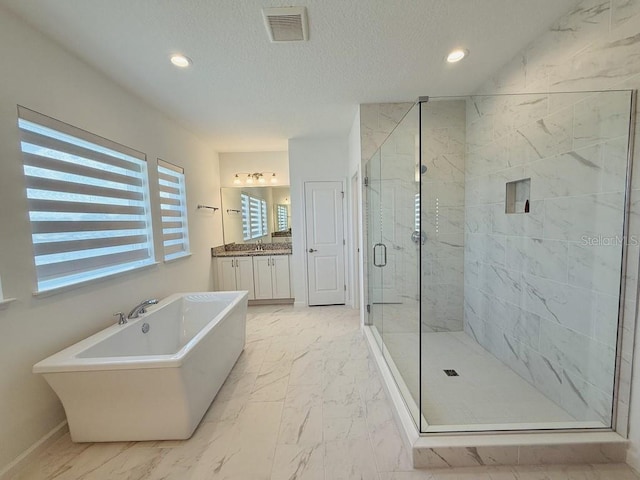 bathroom featuring vanity, visible vents, a freestanding bath, marble finish floor, and a marble finish shower