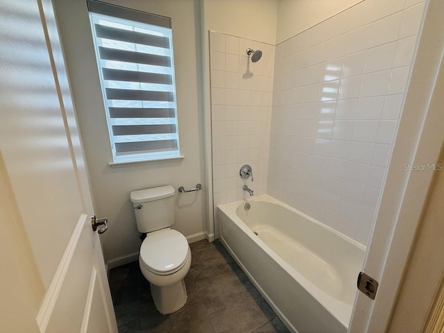 full bath featuring toilet, tile patterned flooring, baseboards, and bathing tub / shower combination