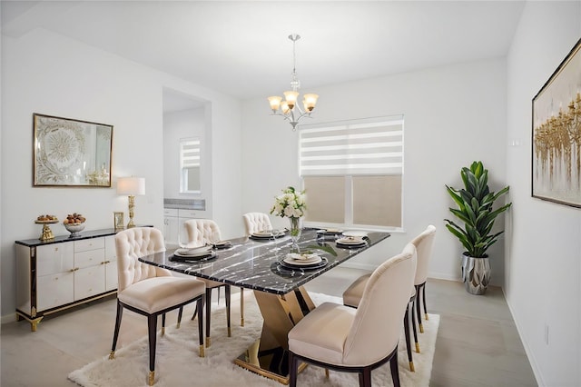 dining room with baseboards and a notable chandelier