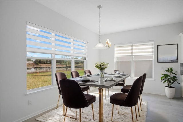 dining space featuring light wood-style flooring and baseboards