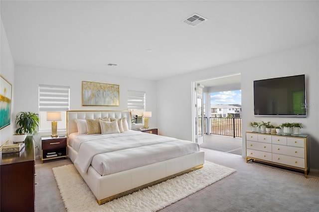 bedroom with visible vents and light colored carpet