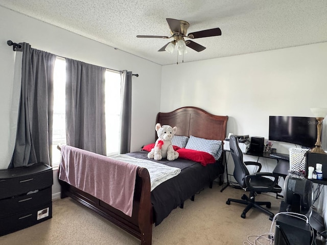 carpeted bedroom with a textured ceiling and ceiling fan