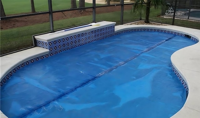 view of pool featuring a lanai