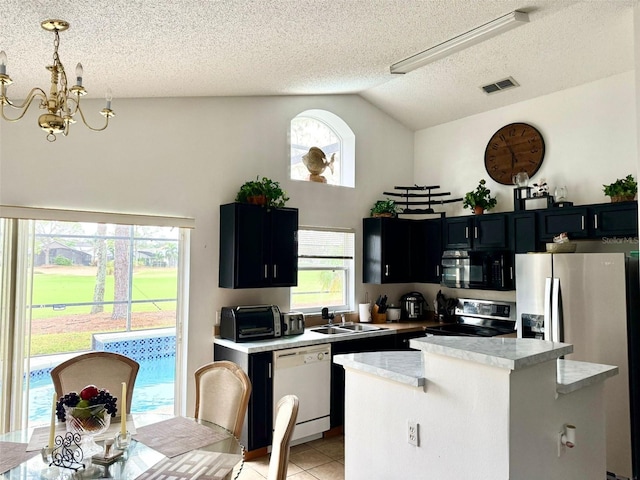 kitchen with pendant lighting, sink, a healthy amount of sunlight, and stainless steel appliances