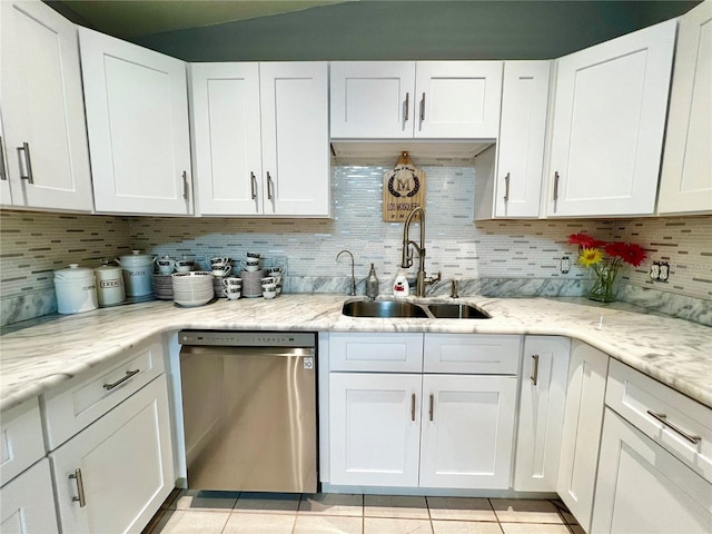 kitchen featuring light stone countertops, sink, stainless steel dishwasher, white cabinets, and light tile patterned floors