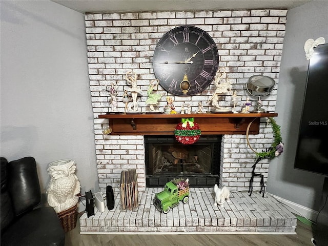 interior details with wood-type flooring and a fireplace