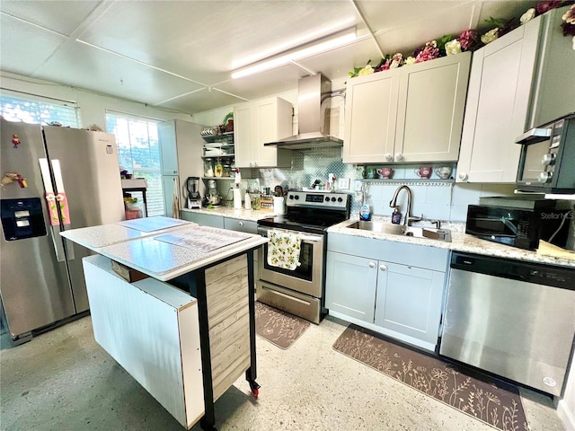 kitchen featuring wall chimney range hood, tasteful backsplash, white cabinetry, sink, and stainless steel appliances