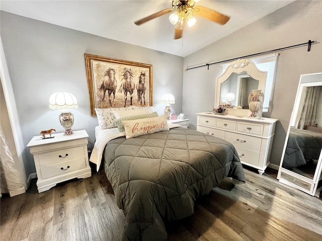 bedroom with ceiling fan, lofted ceiling, and dark hardwood / wood-style flooring