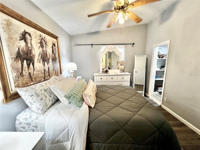 bedroom with lofted ceiling, hardwood / wood-style floors, ceiling fan, a spacious closet, and a closet