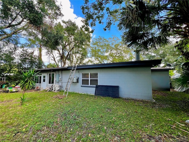 back of house with a lawn