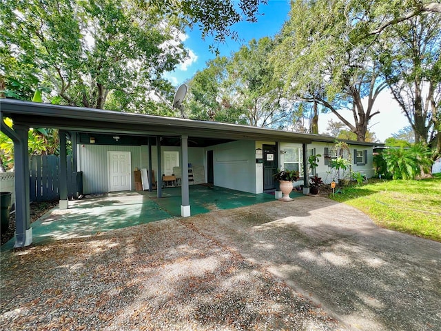 single story home featuring a front yard and a carport