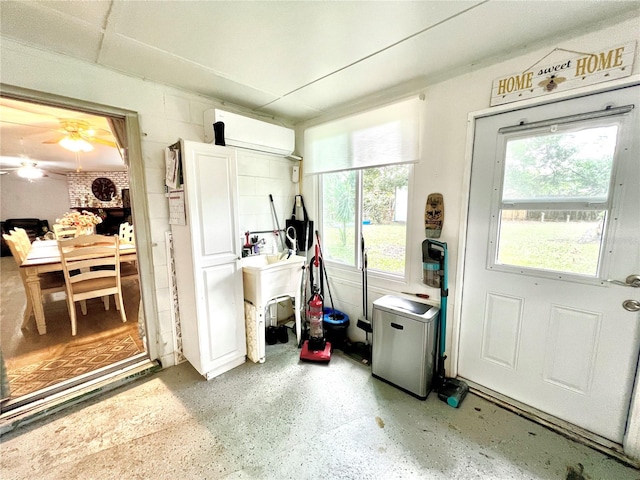 entryway featuring ceiling fan and a wall mounted AC