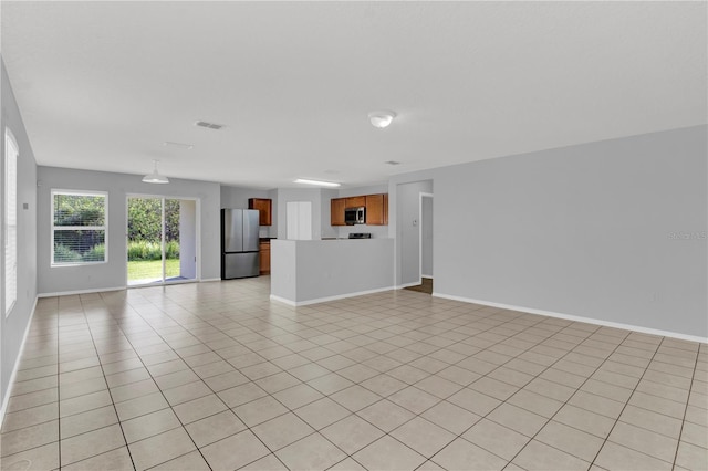 unfurnished living room featuring light tile patterned flooring