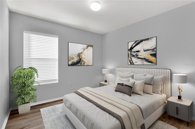 bedroom featuring hardwood / wood-style floors and a textured ceiling