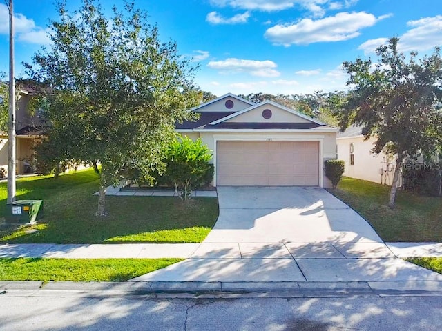 view of front of property with a garage and a front yard