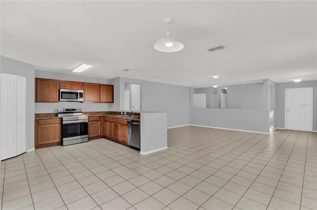 kitchen featuring sink, light tile patterned floors, and stainless steel appliances